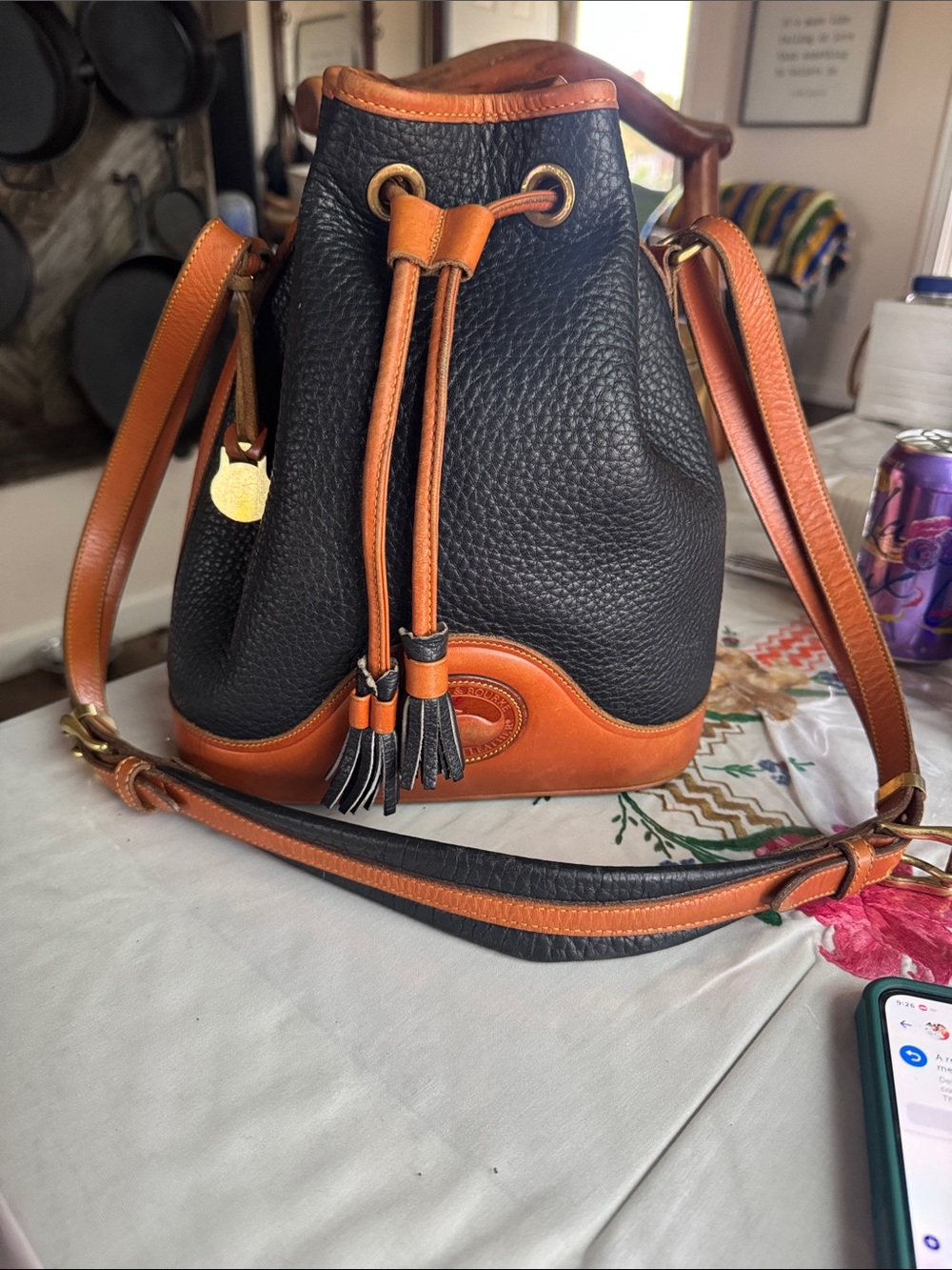 Dooney & Bourke Black and Tan Pebbled Leather Drawstring Bucket Bag